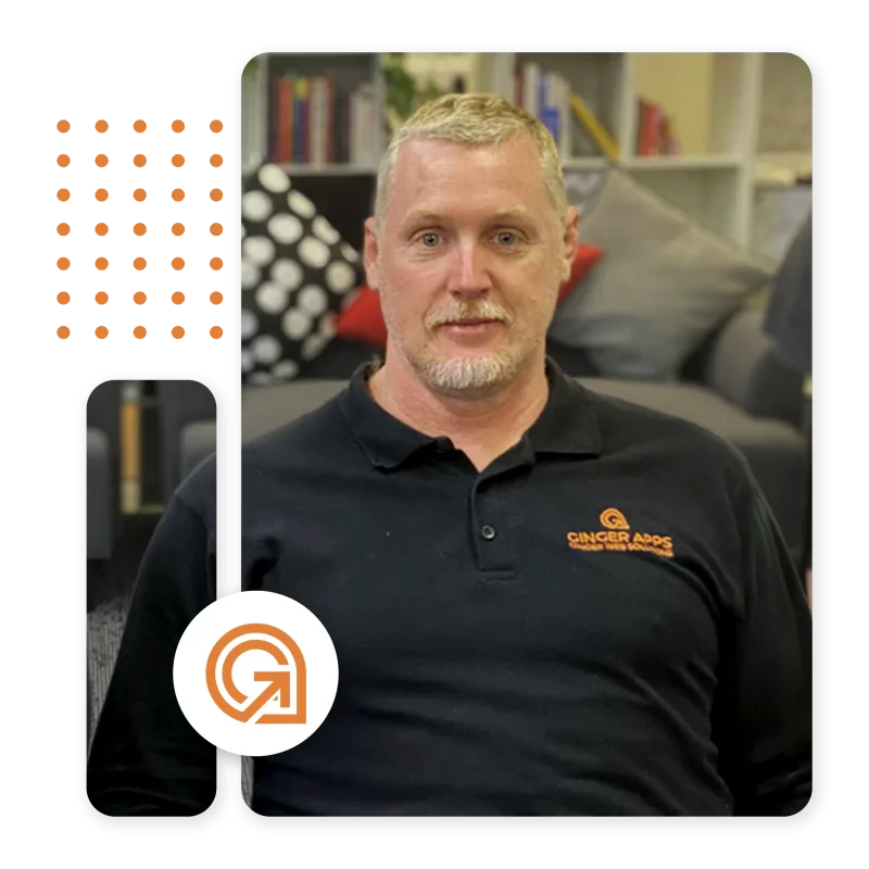Photo of Paul Hashman, founder of Ginger Web Solutions with couch and bookshelves in the background